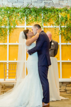 Boho chic greenery framing the wedding ceremony as the perfect backdrop