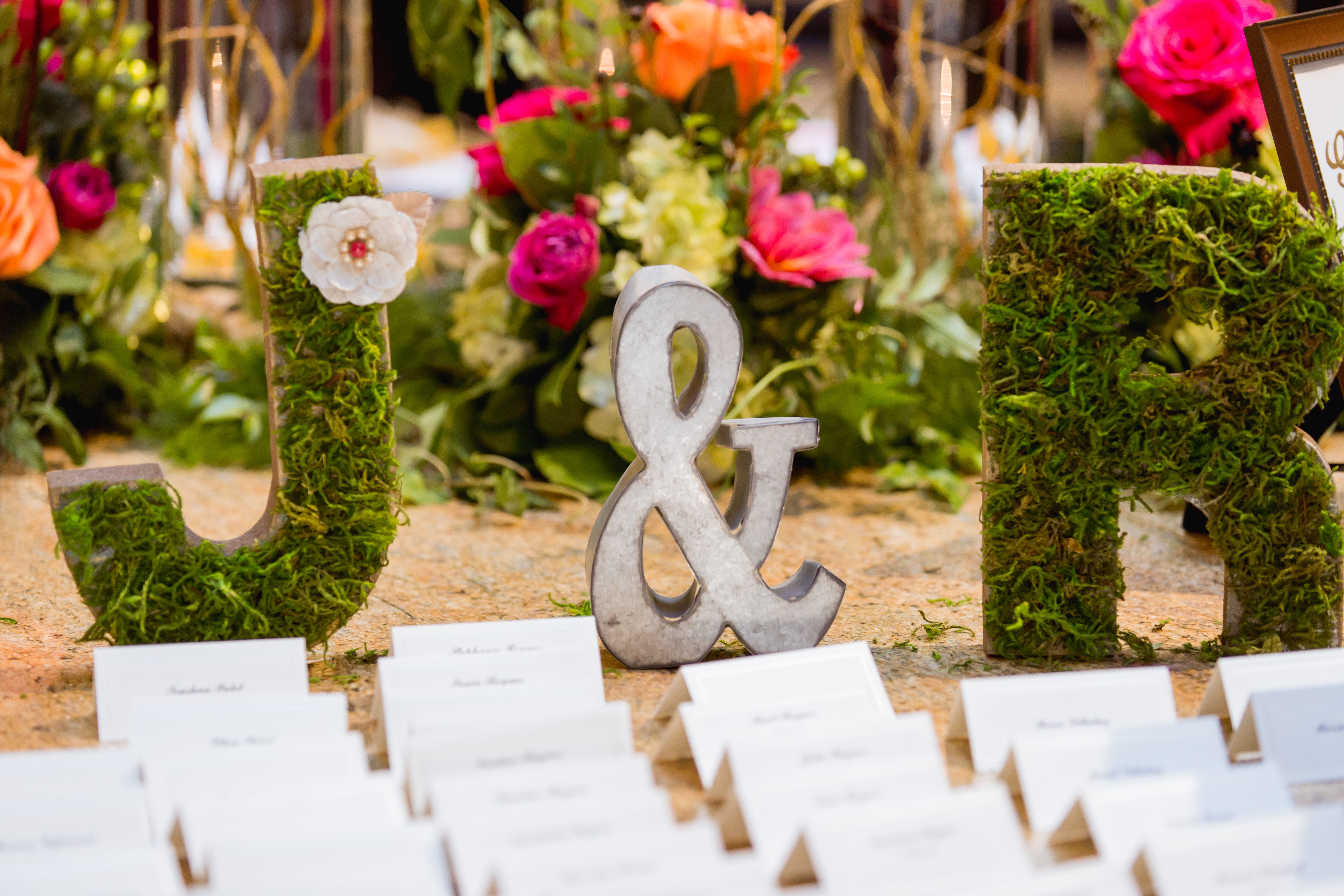 Rustic greenery inspiration for your escort card table! Create a display using your initials made completely from greenery like we did here.