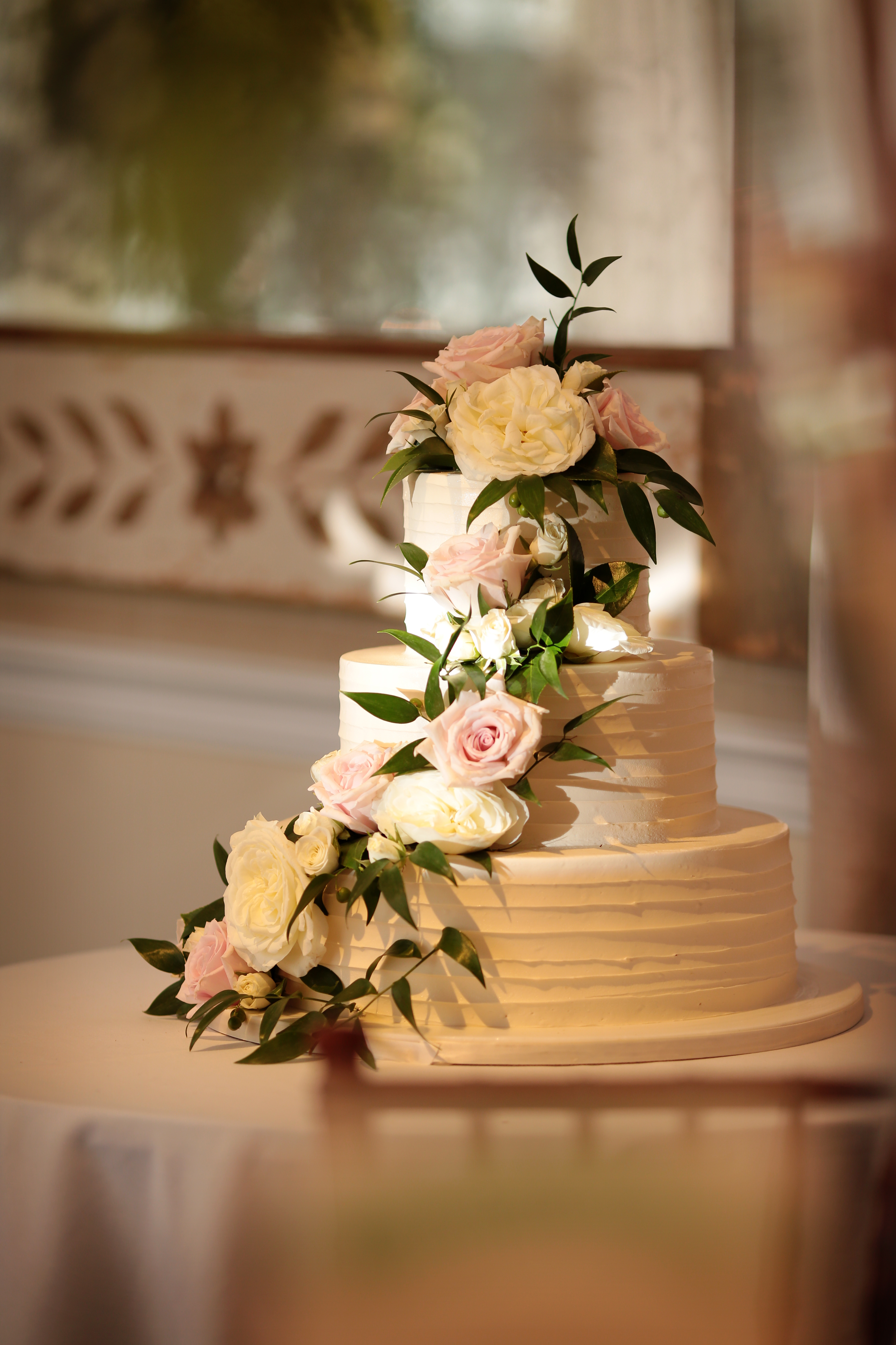 We used greenery to cascade around the wedding cake for our bride and groom that got married at The New York Botanical Gardens.