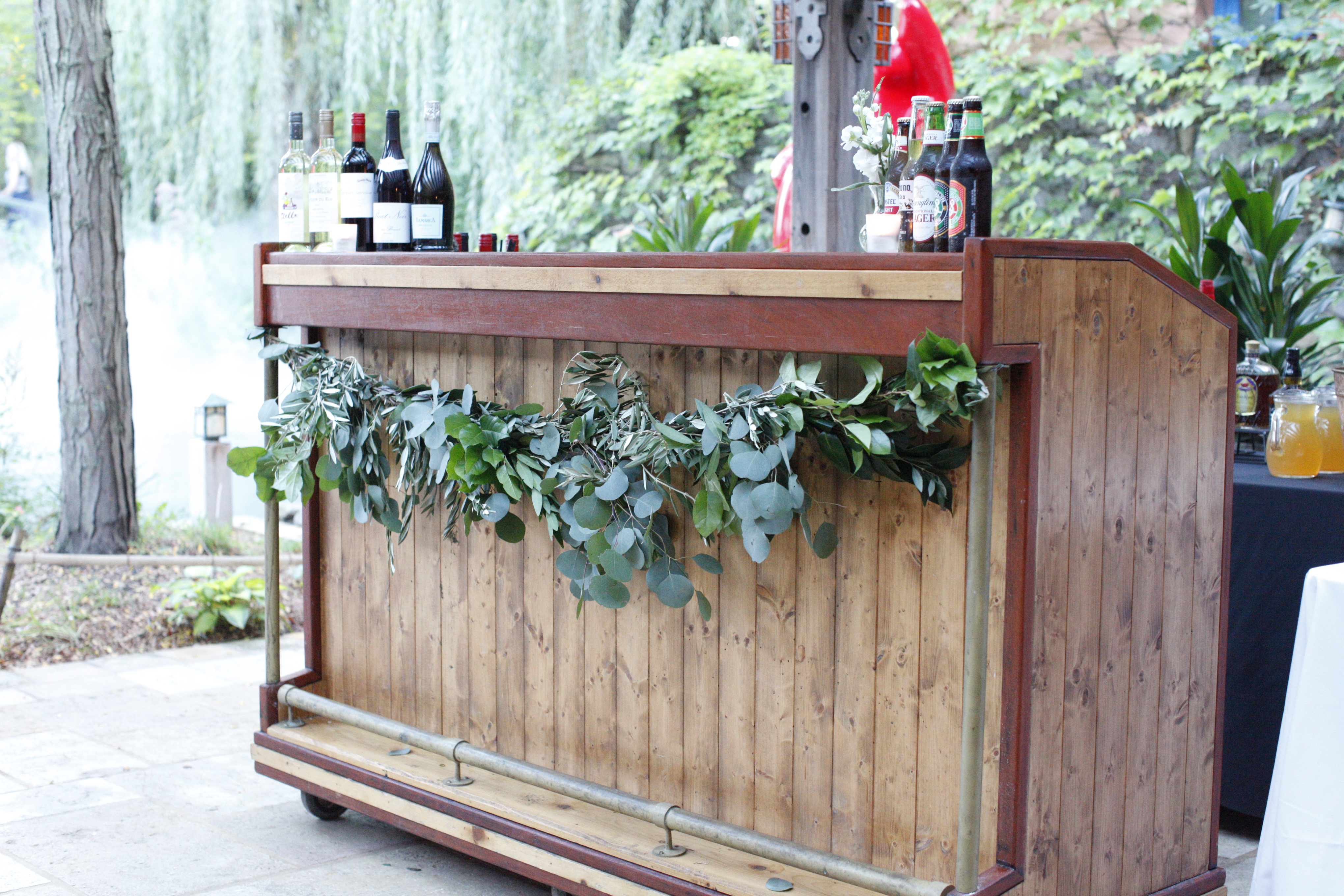 We used greenery throughout this gorgeous outdoor wedding space to bring together the chic organic feel our bride and groom wanted. Read the blog to get all of the details about this garden wedding day!