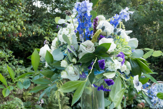 Wedding centerpiece using roses and greenery.