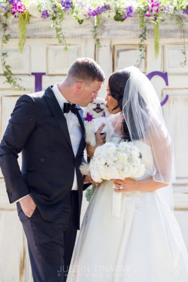 Bride and groom with dog for outdoor wedding