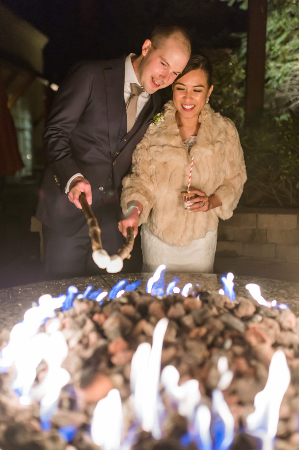 bride and groom roasting smores