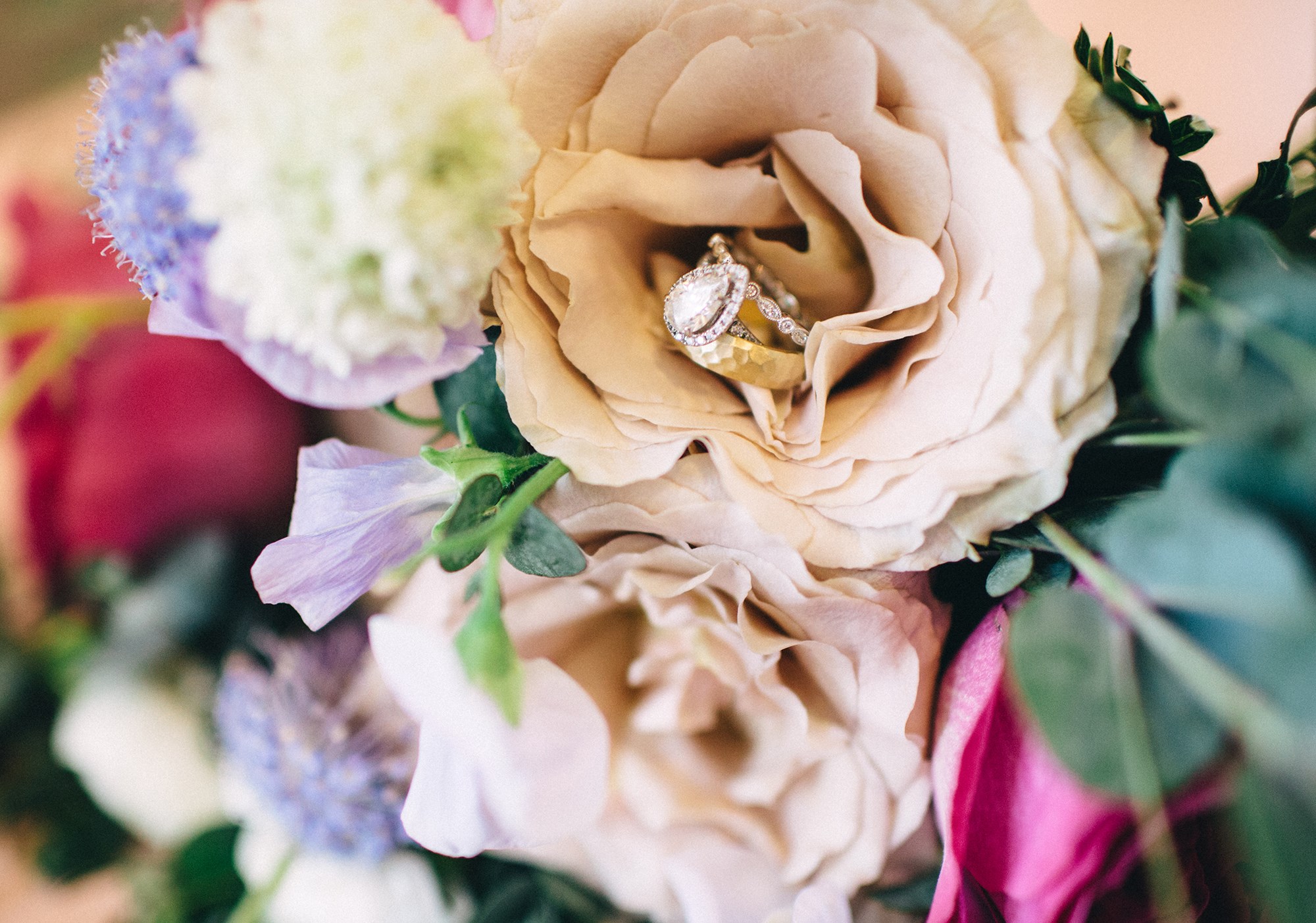 pear shaped engagement ring on bouquet