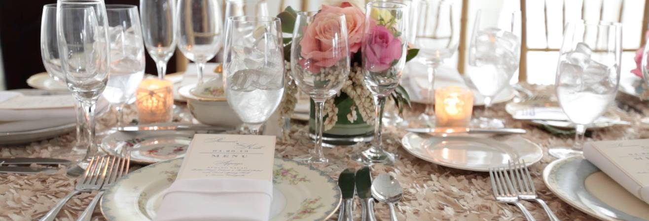 long table at wedding reception in champagne linen with soft pink roses