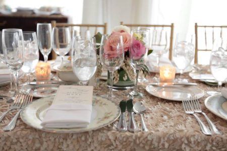 long table at wedding reception in champagne linen with soft pink roses