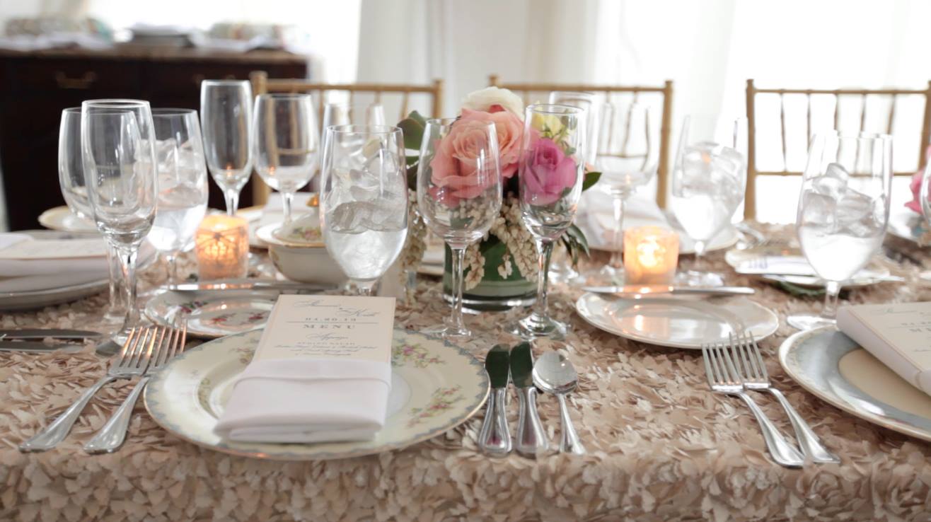 long table at wedding reception in champagne linen with soft pink roses