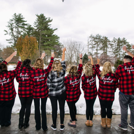 bride and bridal party in plaid toasting