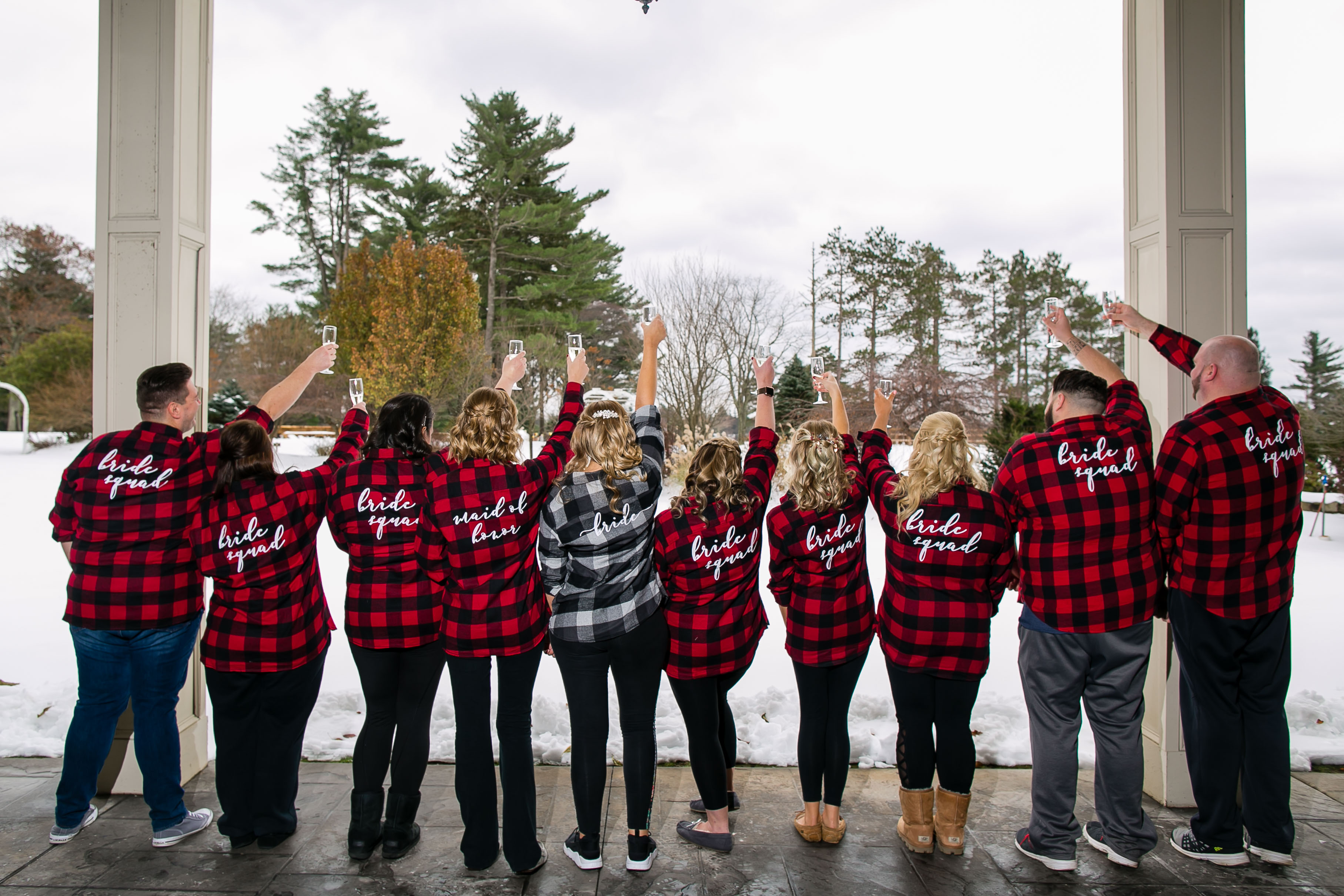 bride and bridal party in plaid toasting