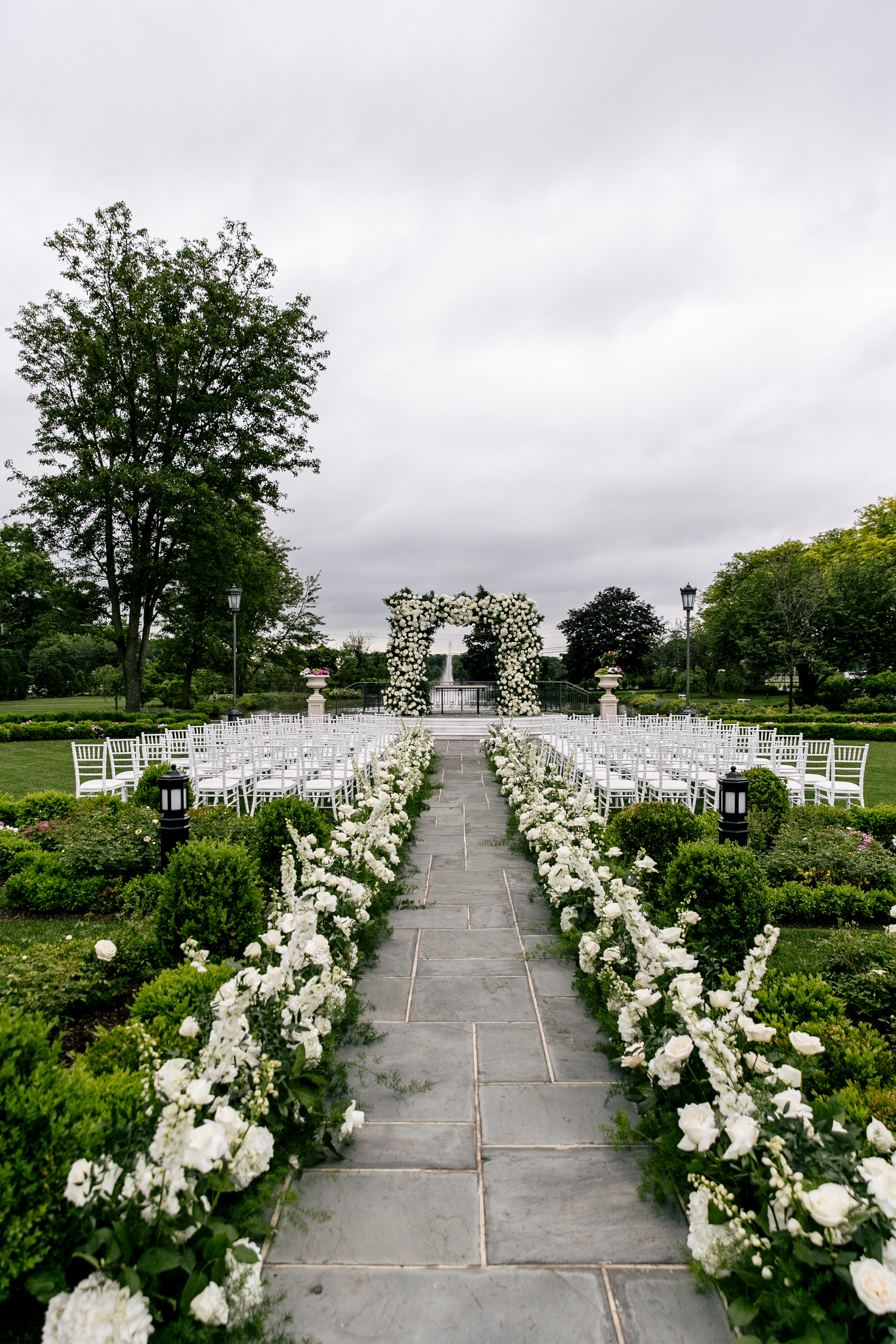 outdoor ceremony location with green and white flowers