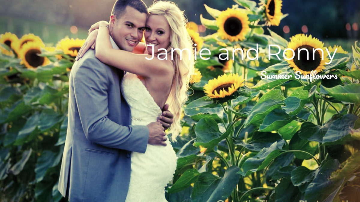 bride and groom embracing in front of sunflowers
