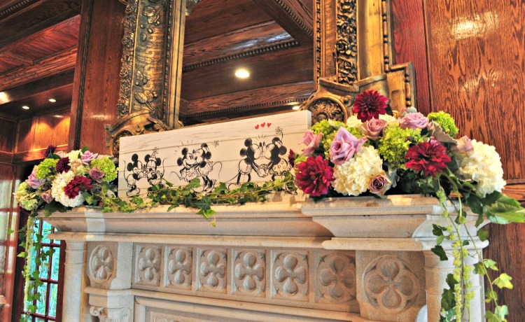 flowers and disney characters on mantle at wedding