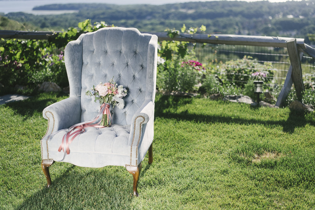 blue chair with pink and white bridal bouquet