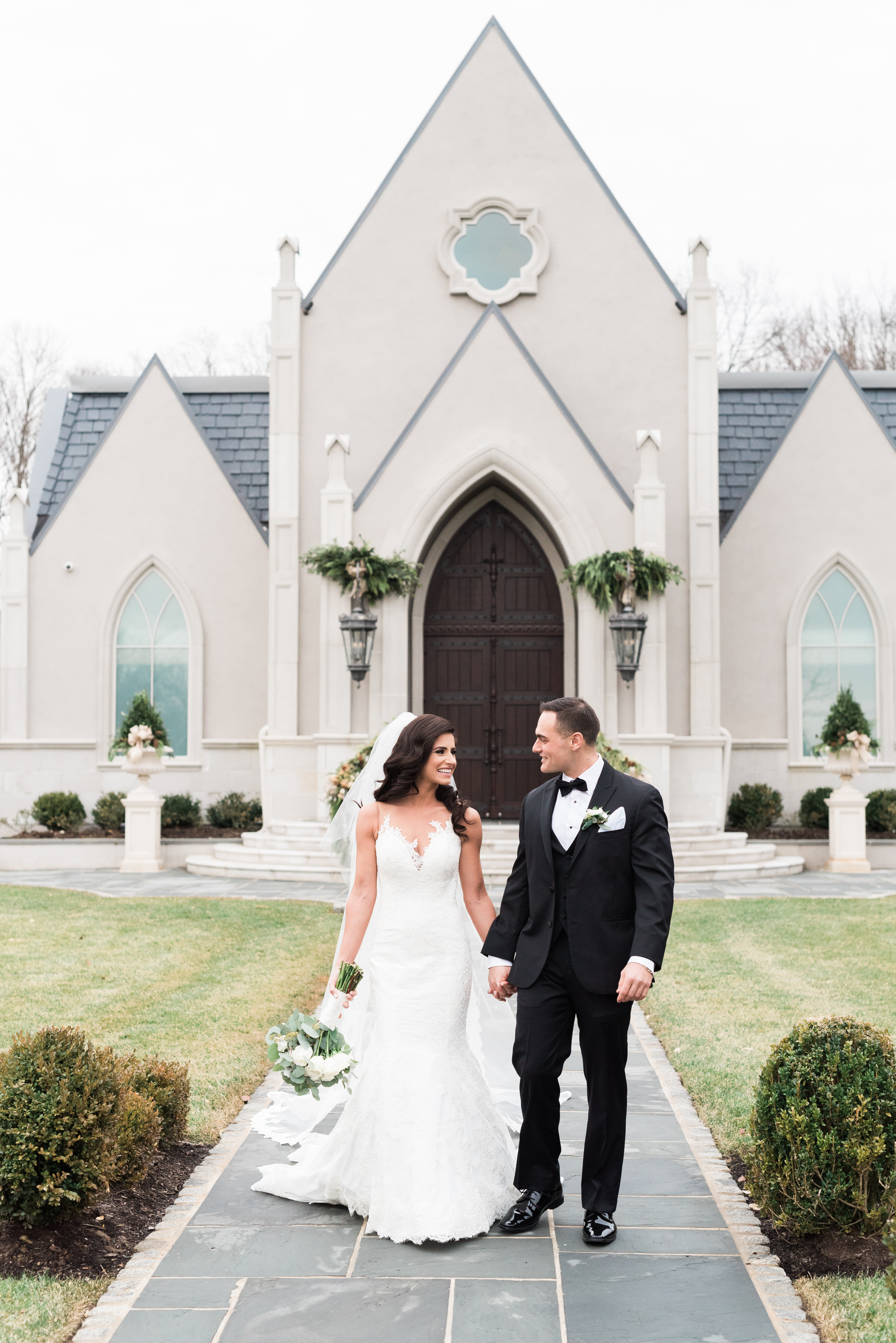 bride and groom walking outside of wedding chapel