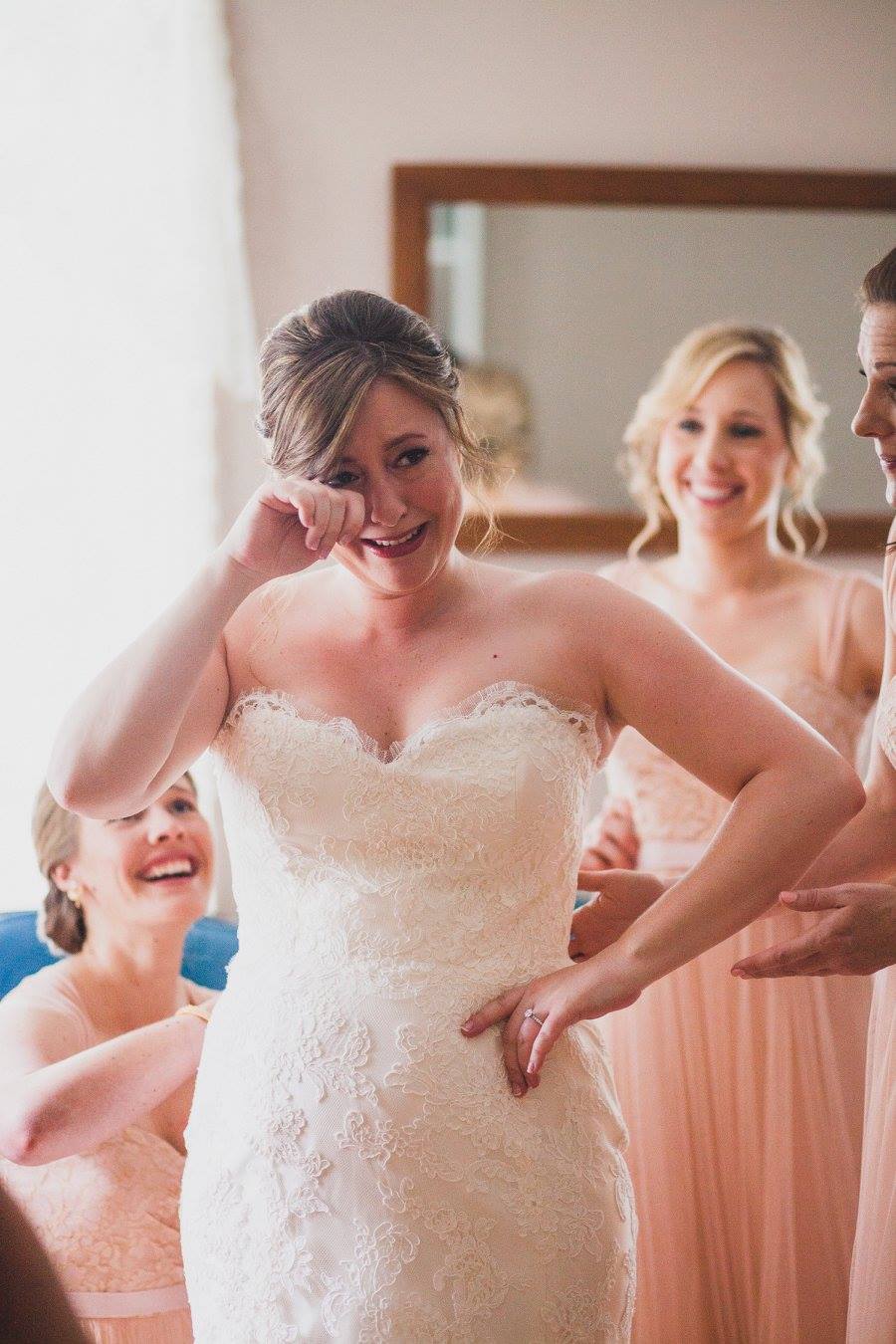 bride crying with bridesmaids