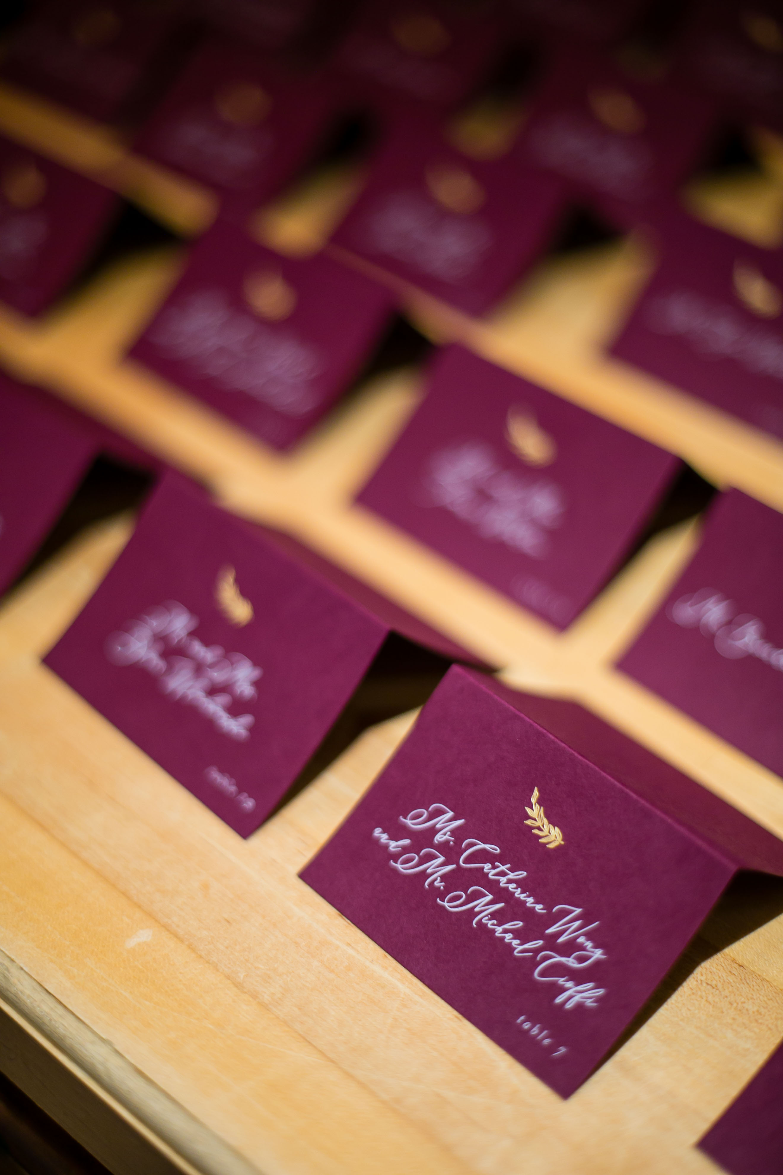 marsala escort cards with gold leaf detail