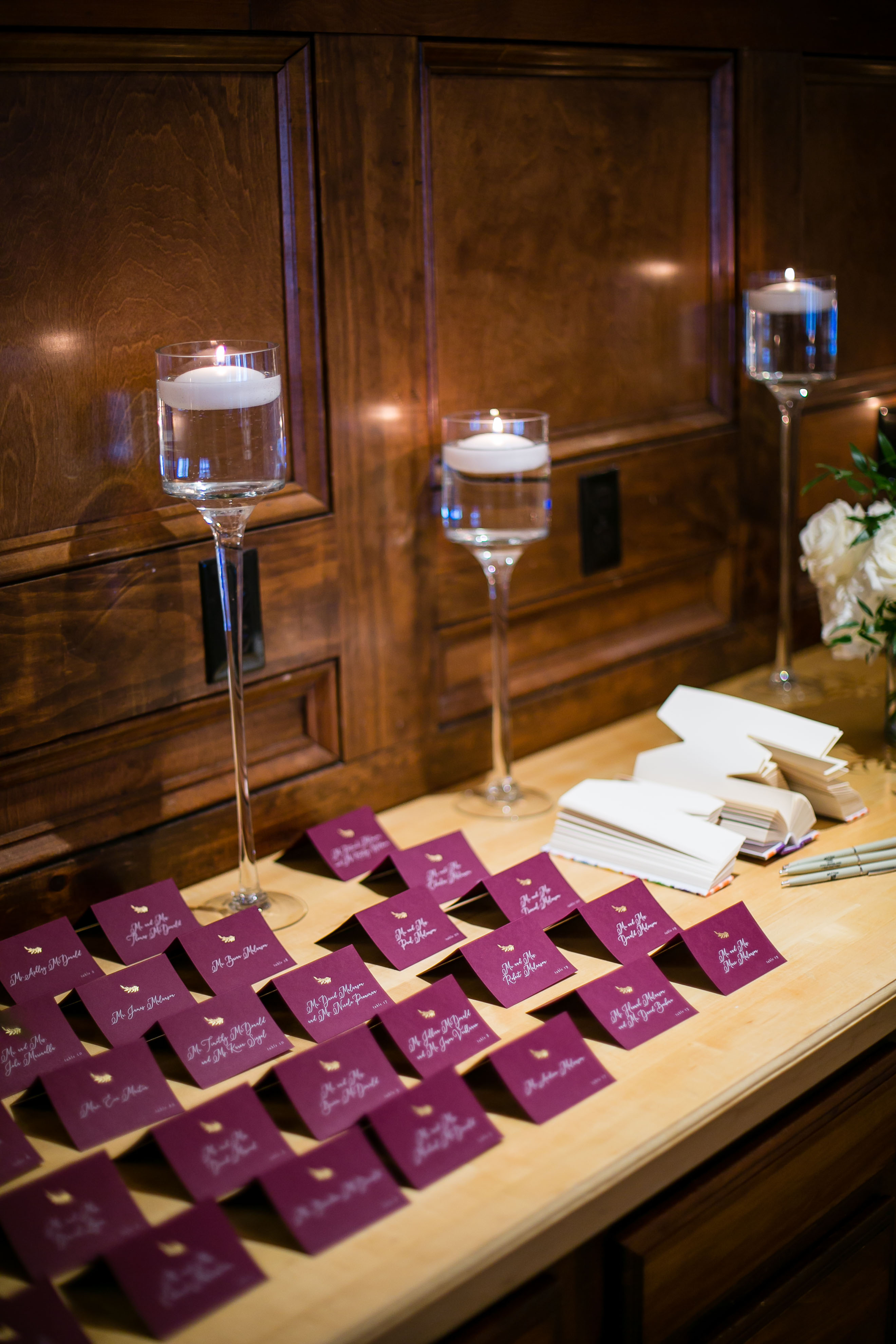 maroon escort cards and candles