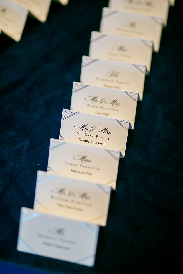 gold foil escort cards on blue linen