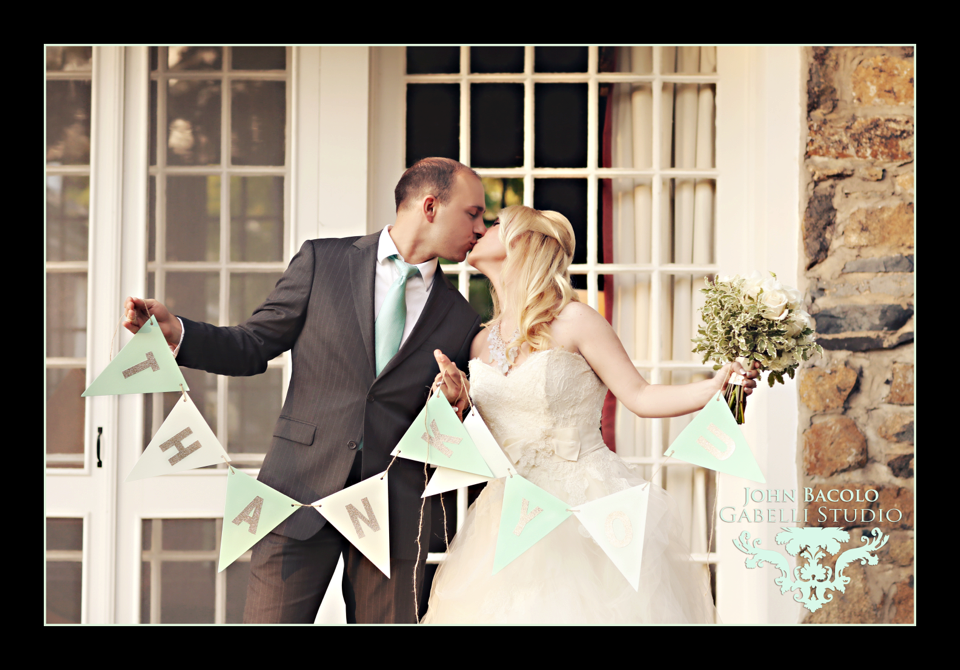 bride and groom with thank you sign