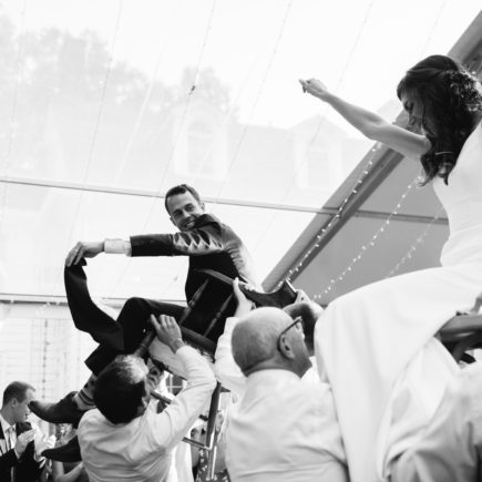 bride and groom lifted up for hora