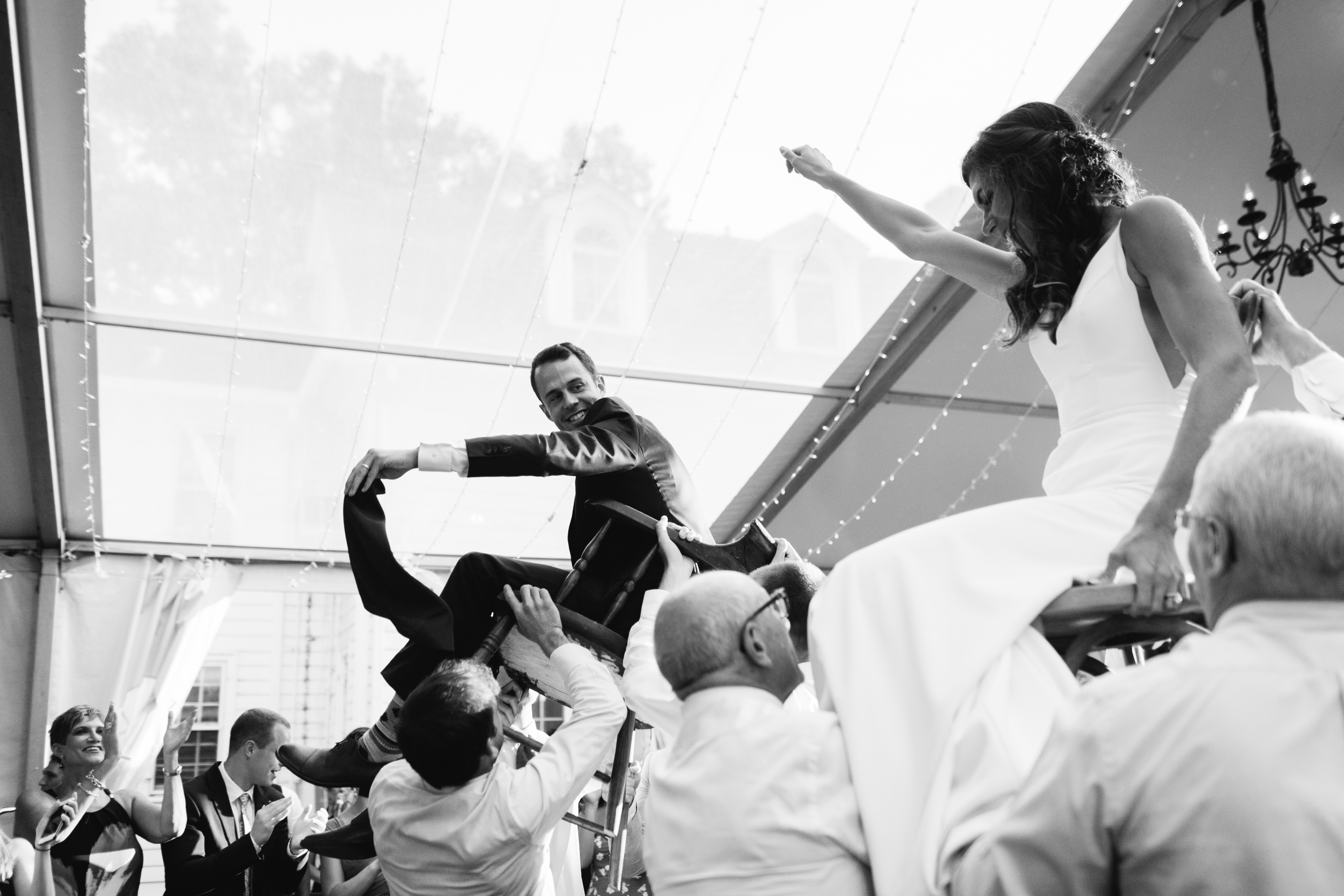 bride and groom lifted up for hora