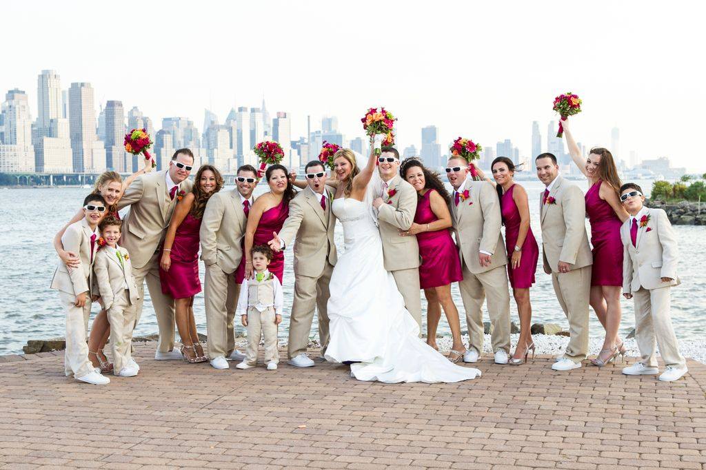 bridesmaids in short hot pink dresses and groomsmen in khaki suits