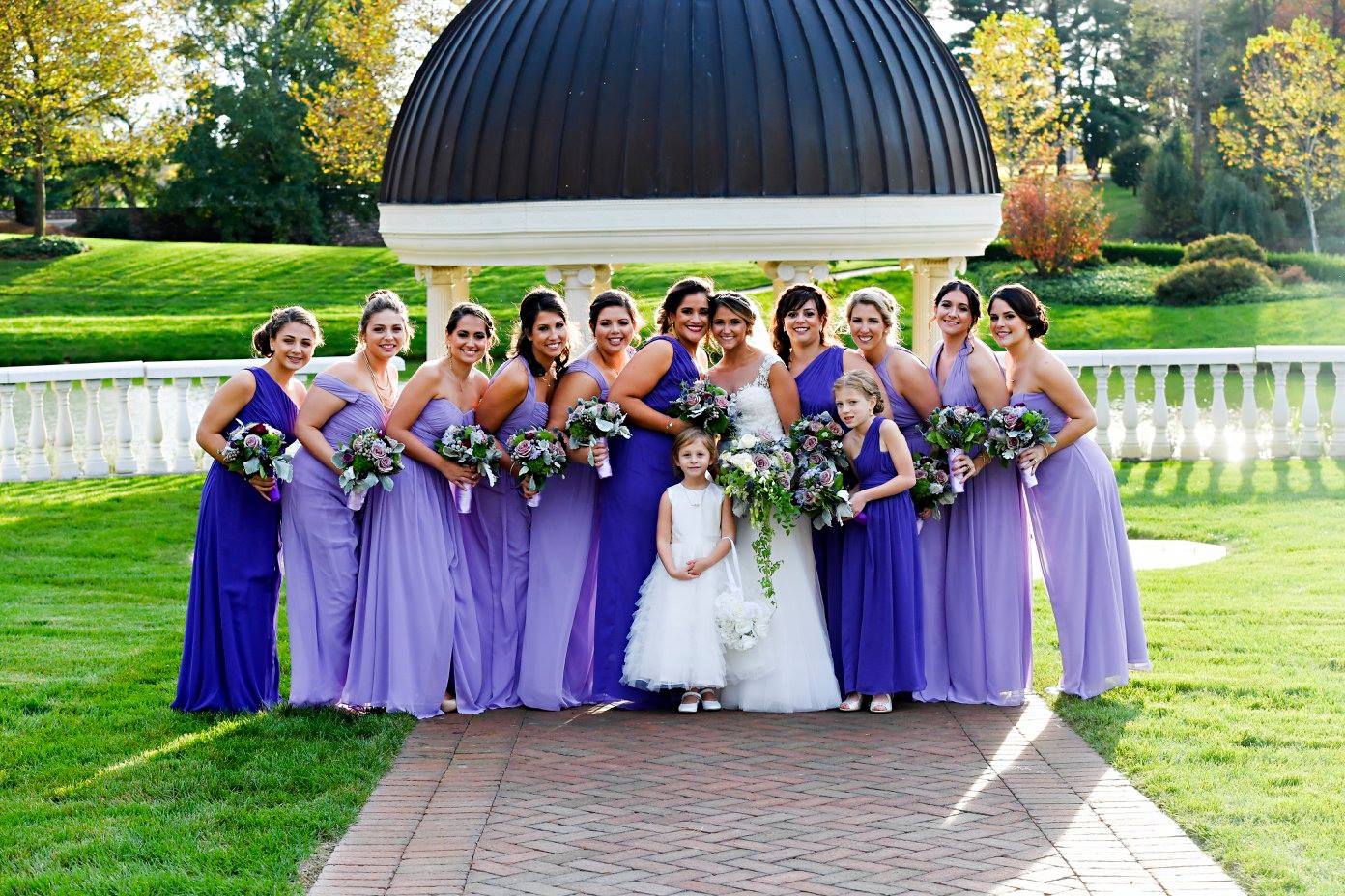bridesmaids in two shades of long purple gowns