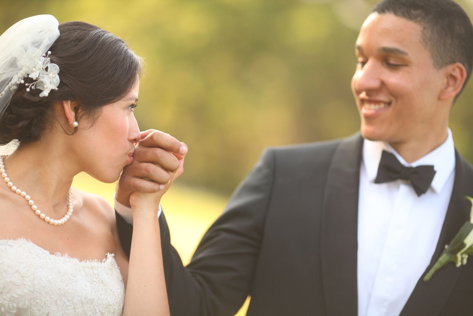 bride kissing groom's hand