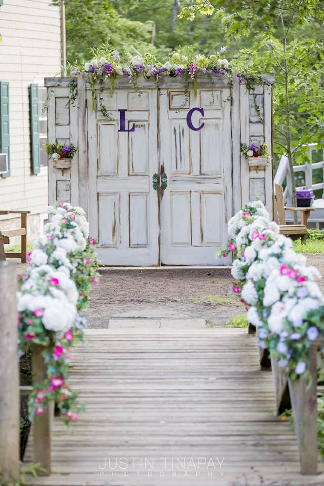 flowers on bridge leading to rustic door