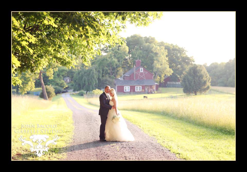 bride and groom outside by barn