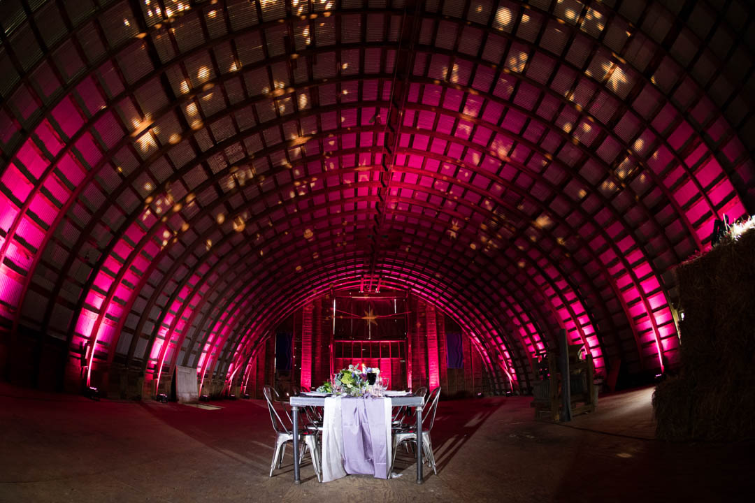 barn wedding with pink lighting