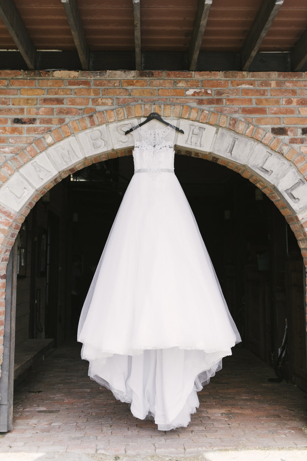 wedding gown hanging in doorframe