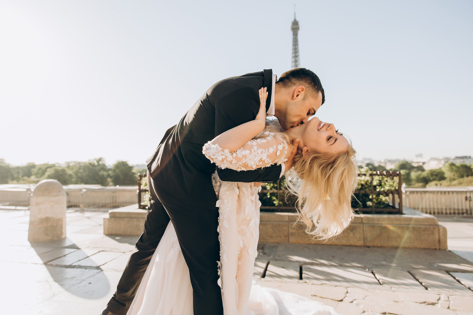 groom kissing bride in paris