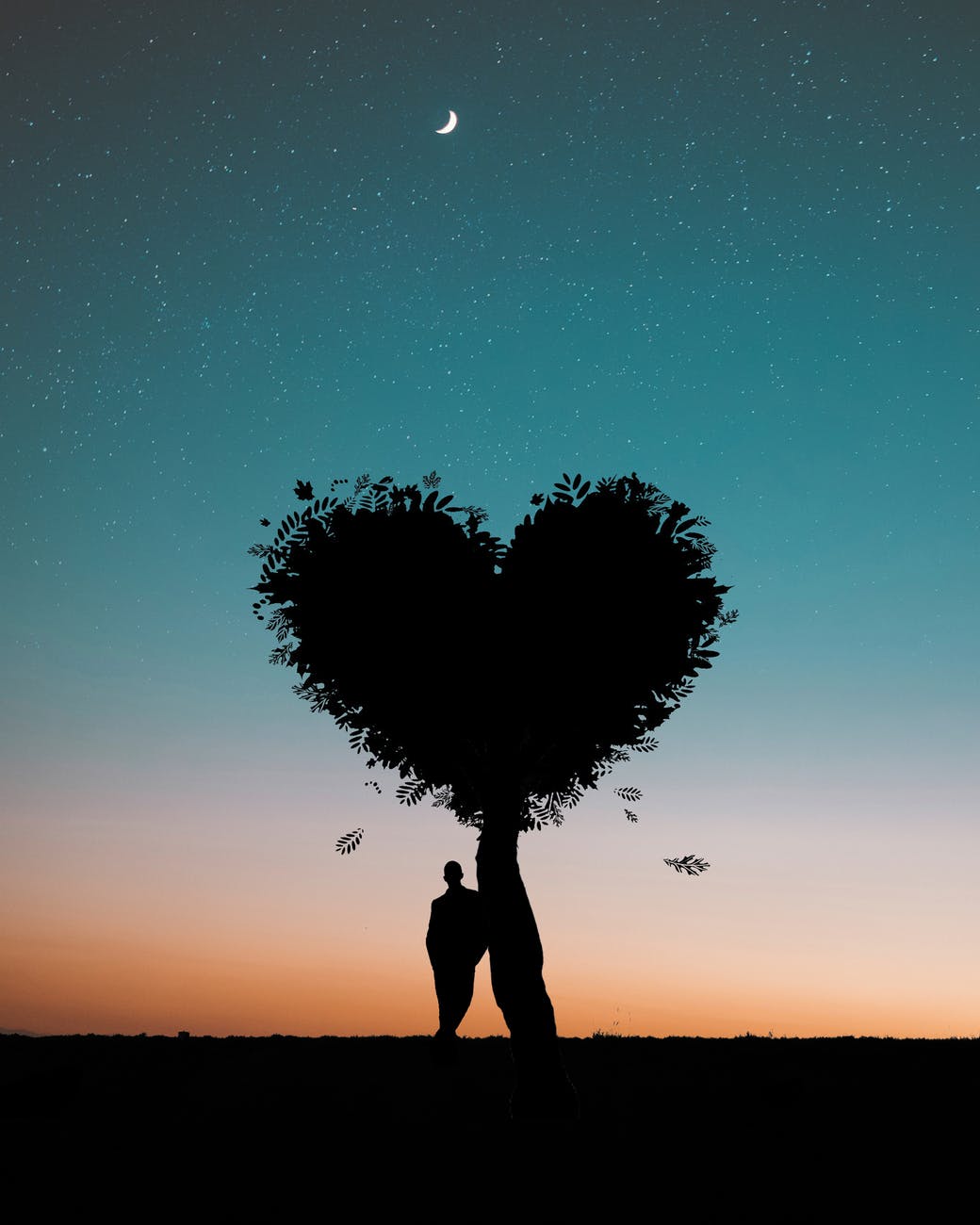 man leaning against tree with heart