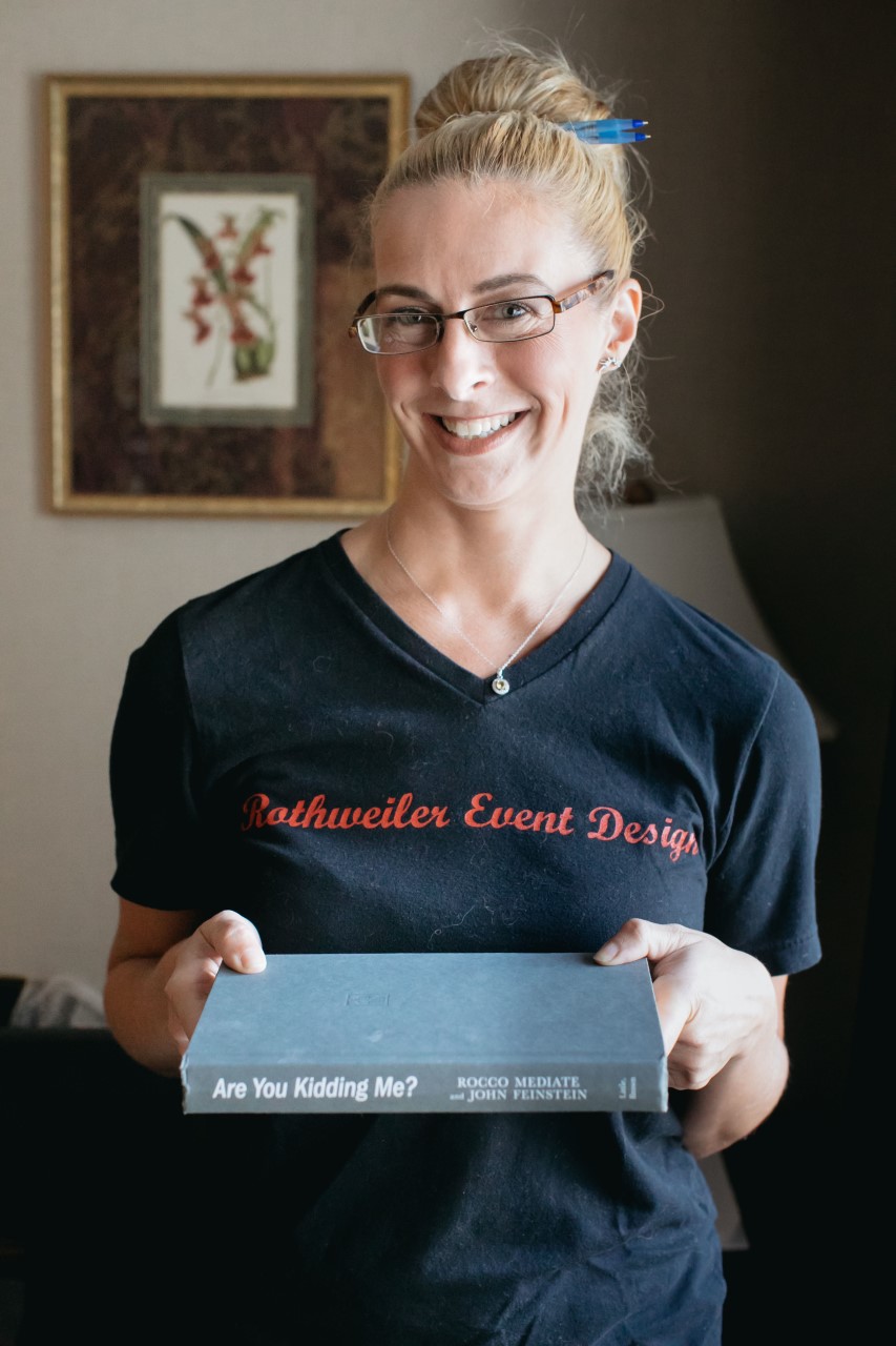 wedding planner holding a book that says are you kidding me