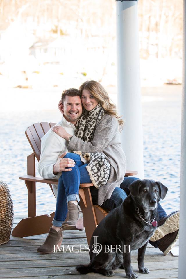 couple sitting outside together on chair with dog