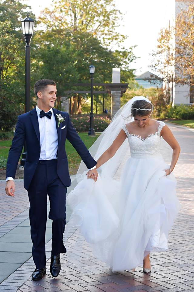 bride and groom walking hand in hand