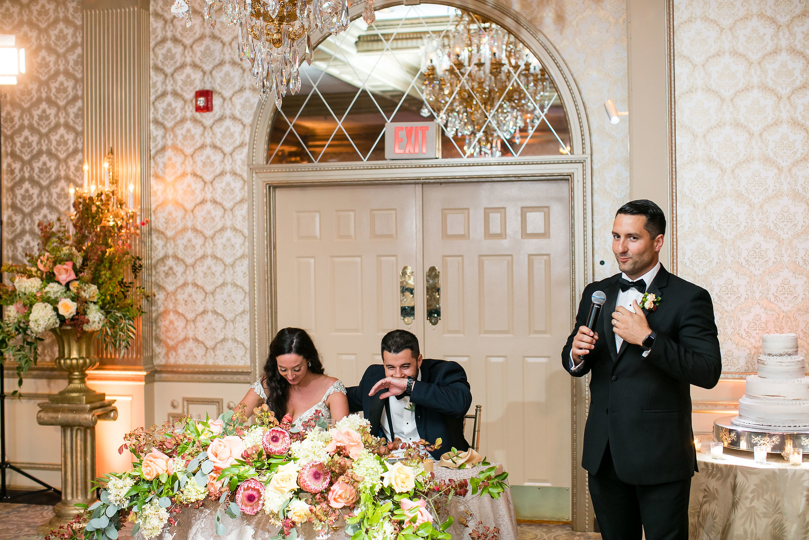 bride and groom laughing at best man wedding toast