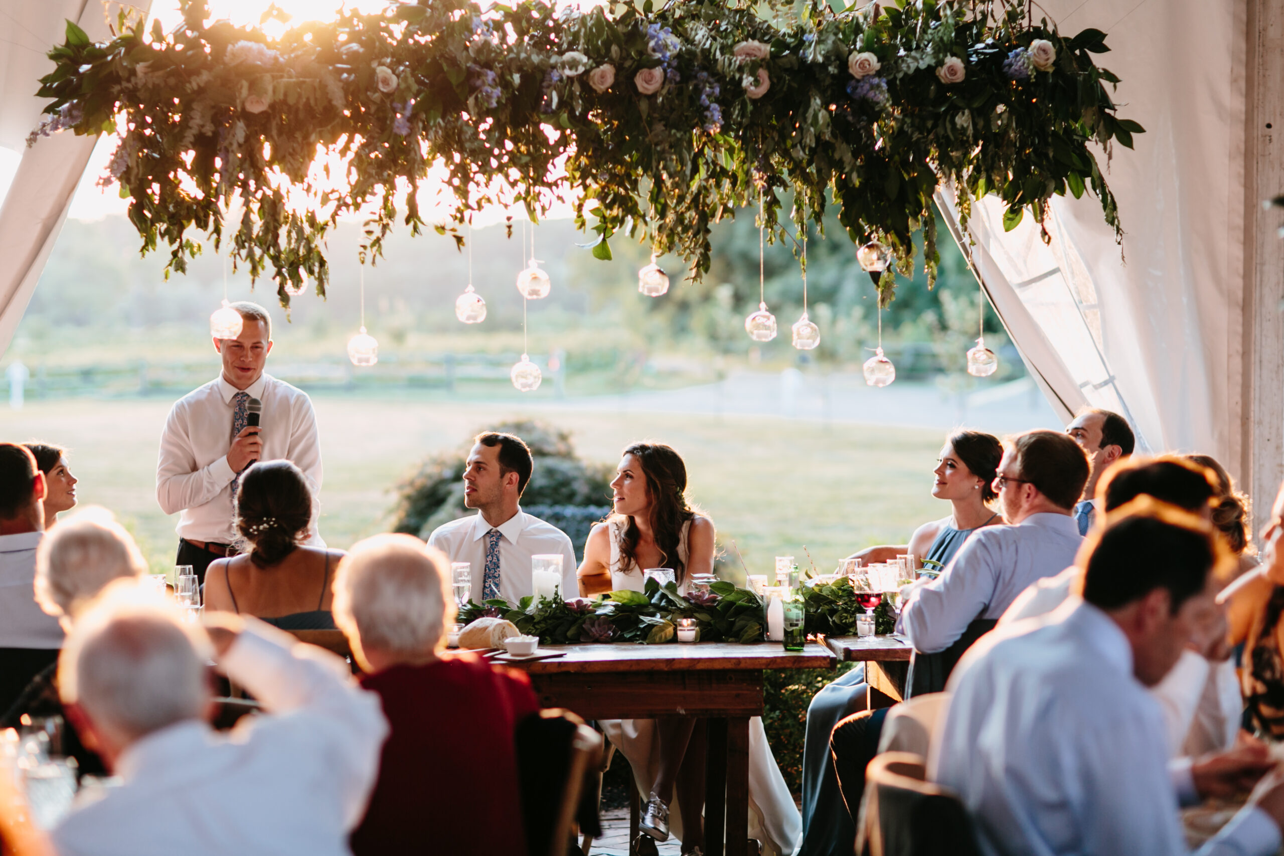 bride and groom listening to wedding speech