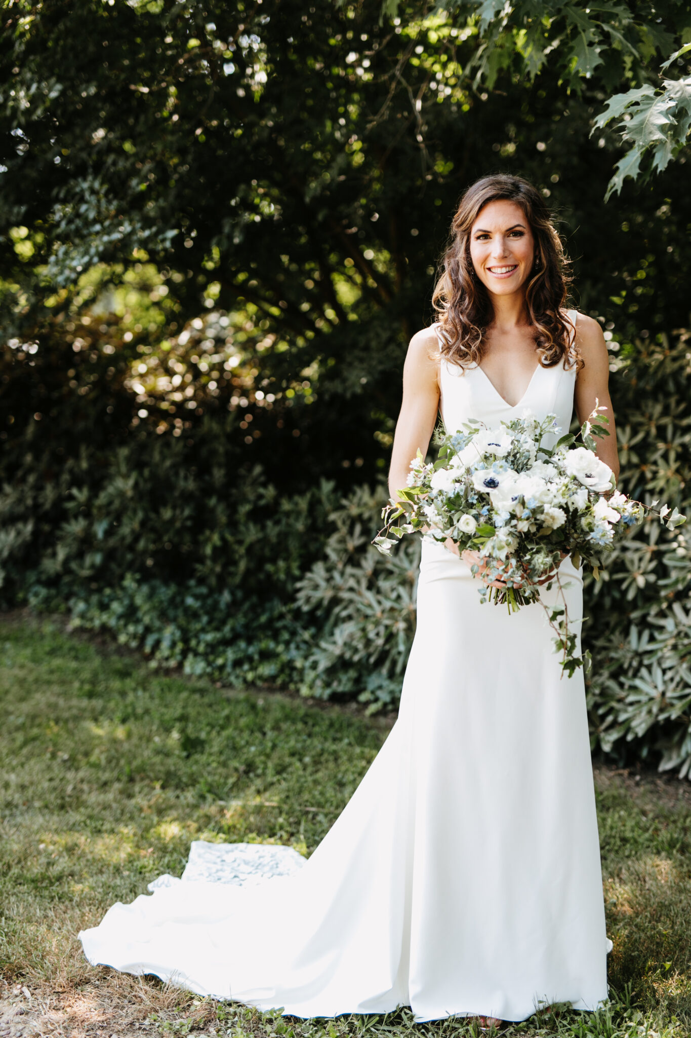 bride holding bouquet outdoors