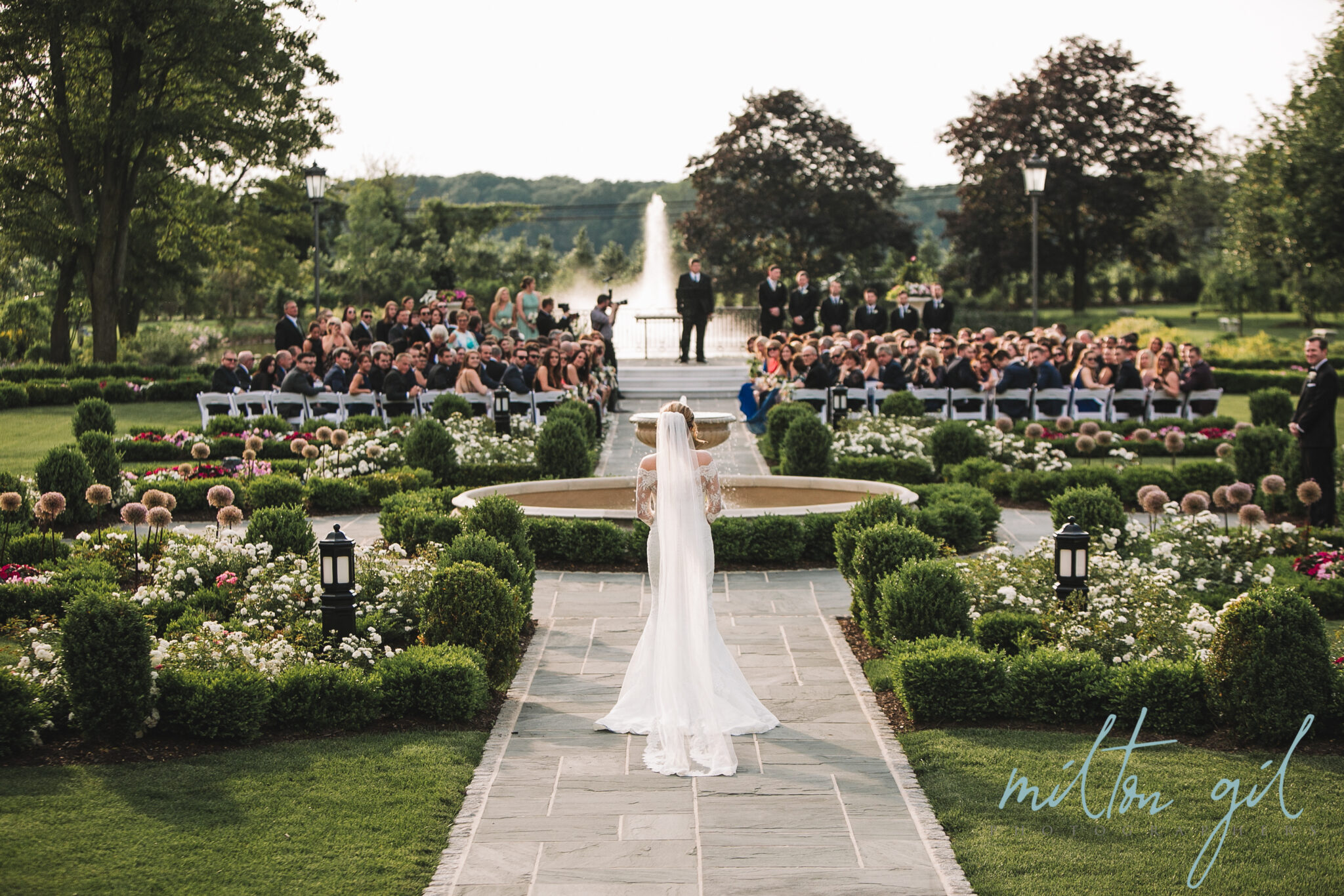 bride walking down aisle outdoors