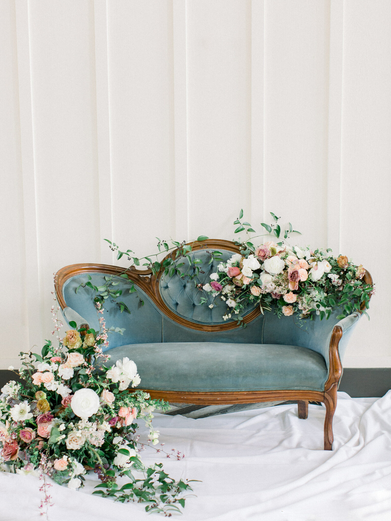 dusty blue vintage couch covered in flowers