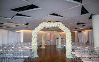 all white floral arch for wedding ceremony