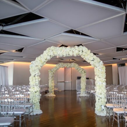 all white floral arch for wedding ceremony