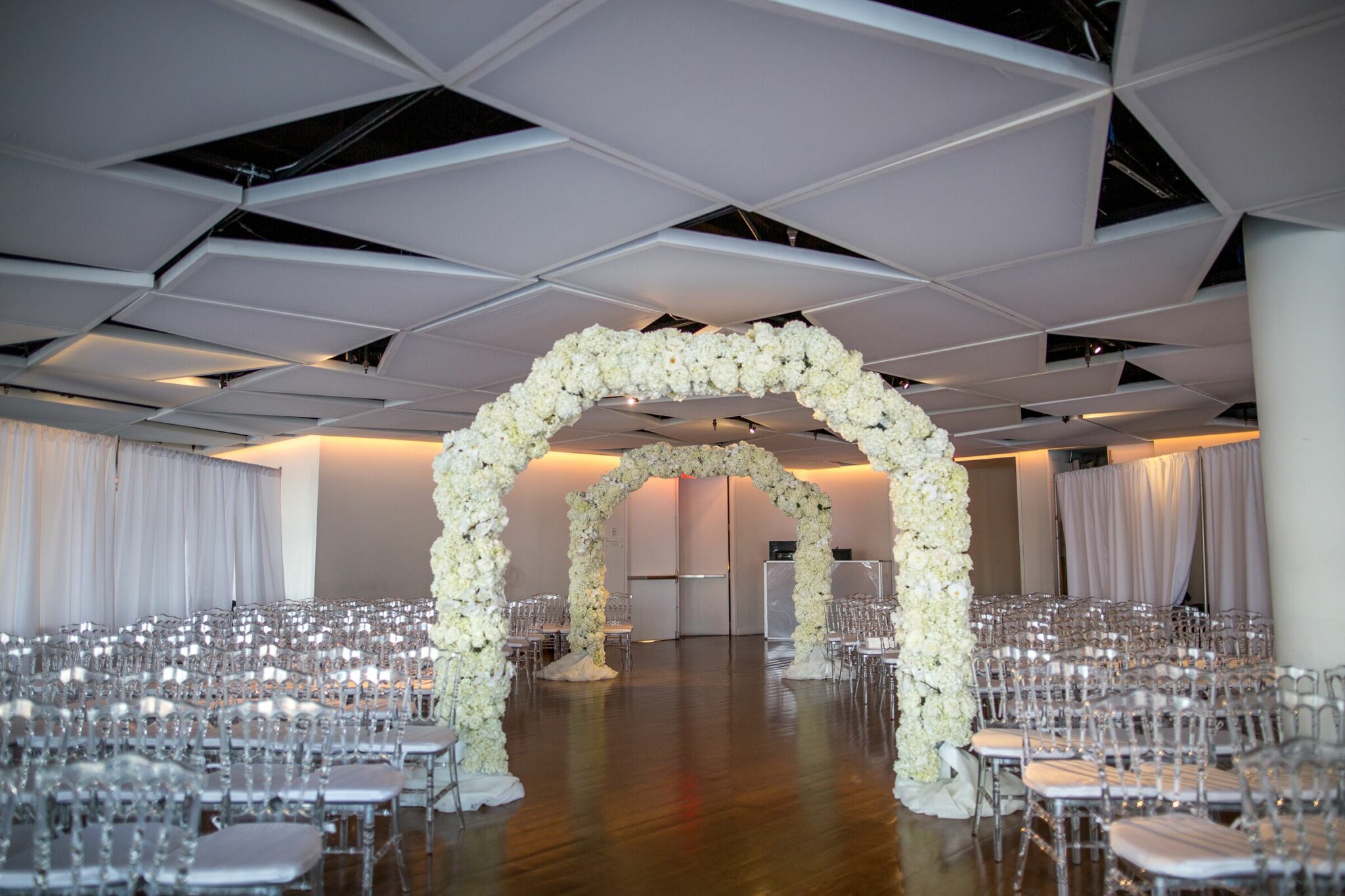 all white floral arch for wedding ceremony