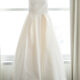 wedding gown hanging in window