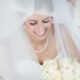 bride smiling with veil on