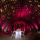 barn wedding with pink ceiling lighting