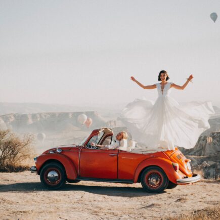 bride standing on car