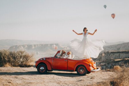 bride standing on car